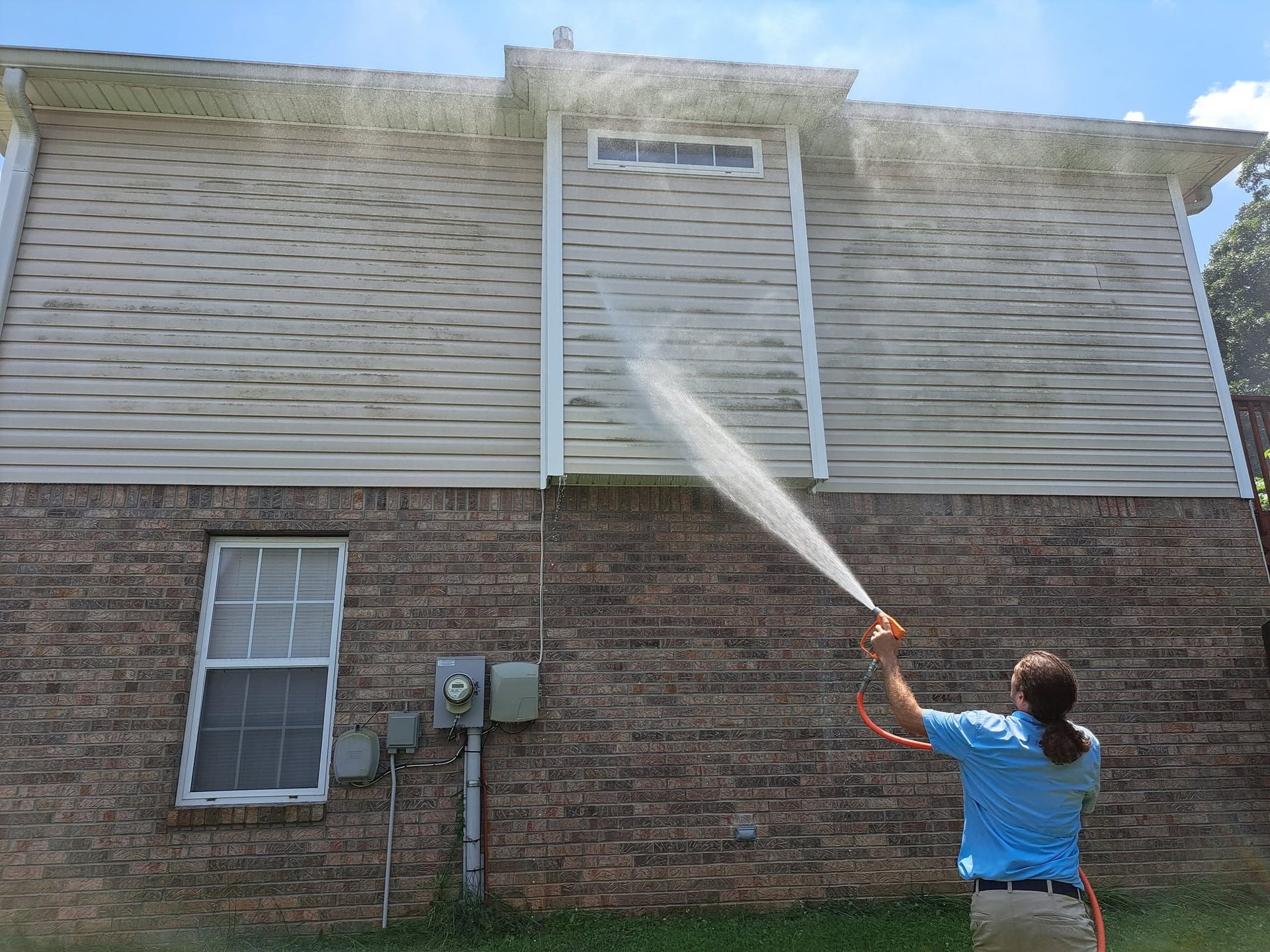 SparClean technician soft-washing vinyl siding in Chattanooga