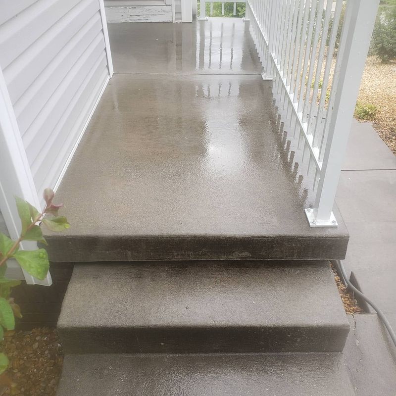 Concrete porch landing with dirt and stains before cleaning