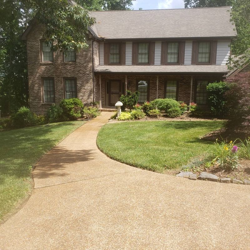 Same curved concrete walkway restored after pressure washing