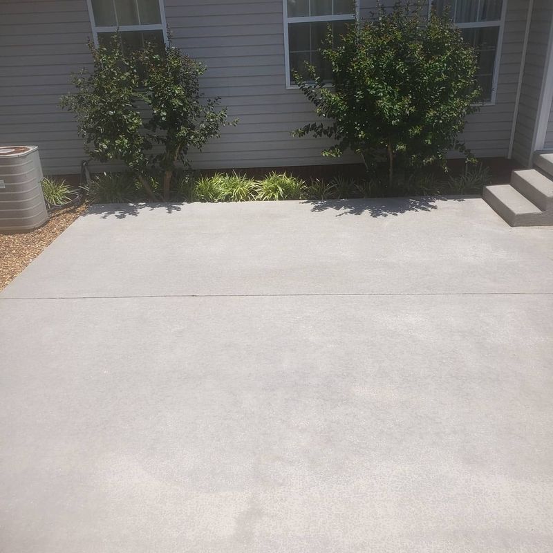 Same rear concrete patio pad cleaned after pressure washing