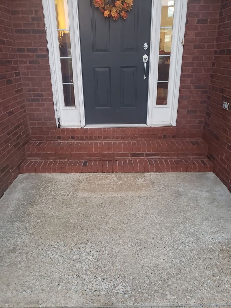 Same brick porch after pressure washing — clean and even finish