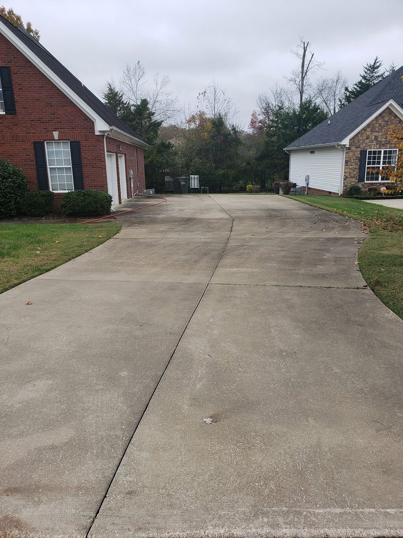 Subdivision driveway stained with dirt before pressure washing
