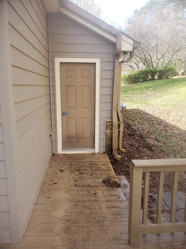 Wood deck landing caked with mud and grime before cleaning