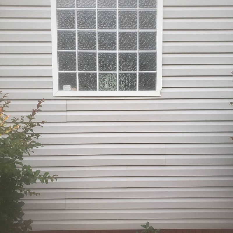 Same glass block window area after soft washing — clear finish